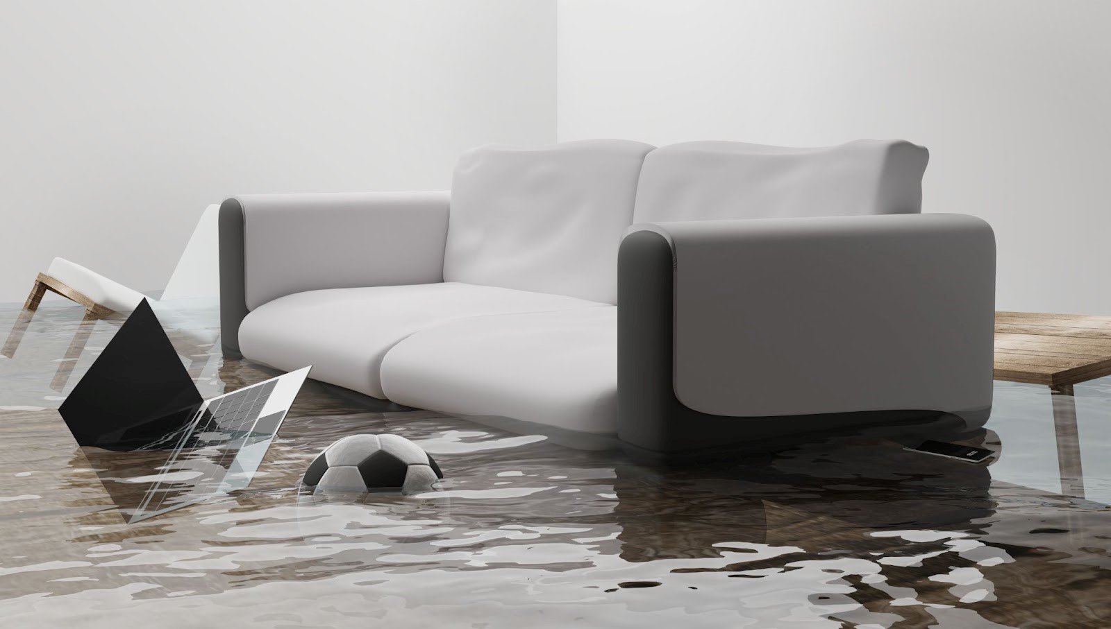 Couch, chair, laptop and soccer ball in a foot of water damage due to flooding in the house