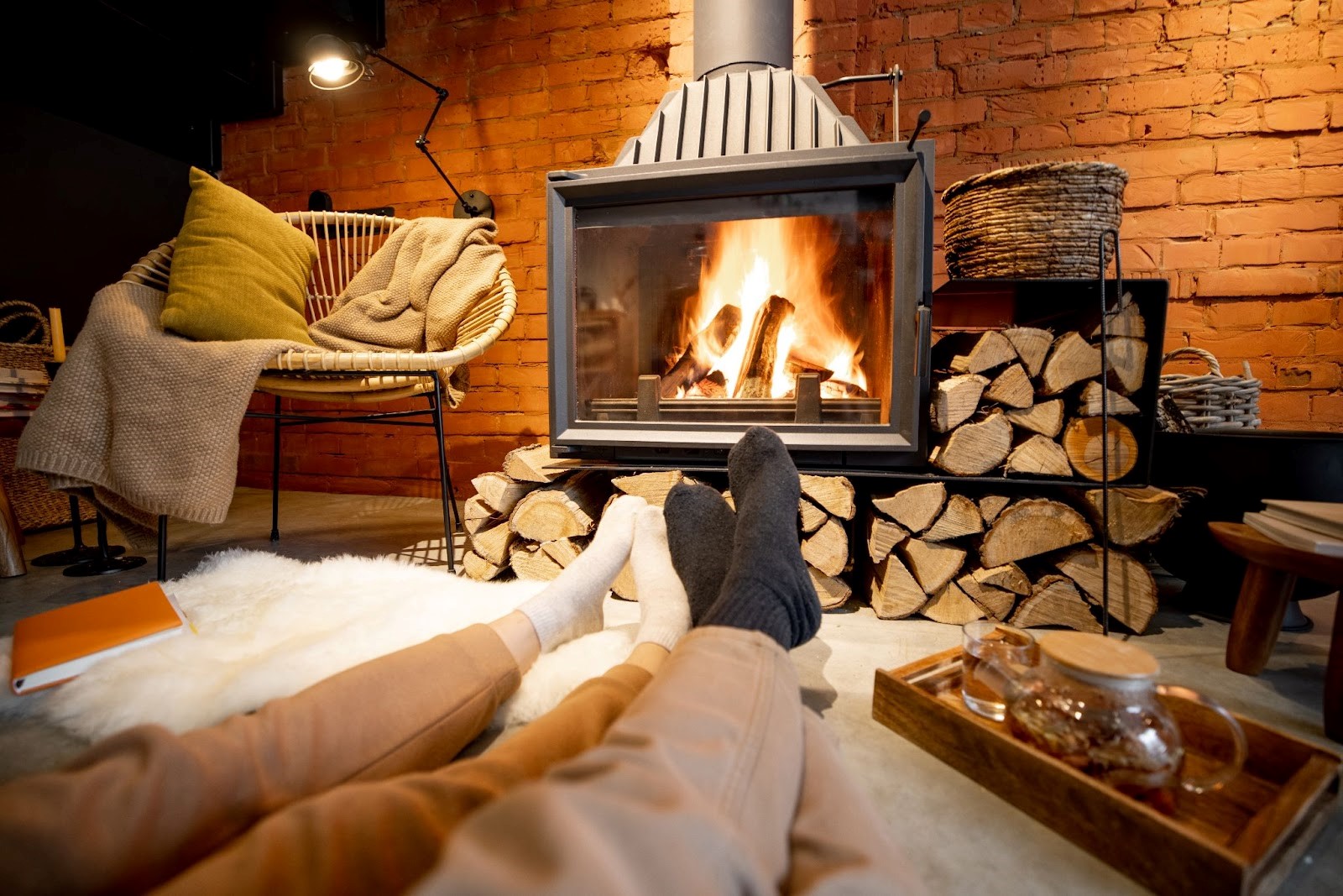 Couple in wool socks lying by the burning fireplace in a cozy house