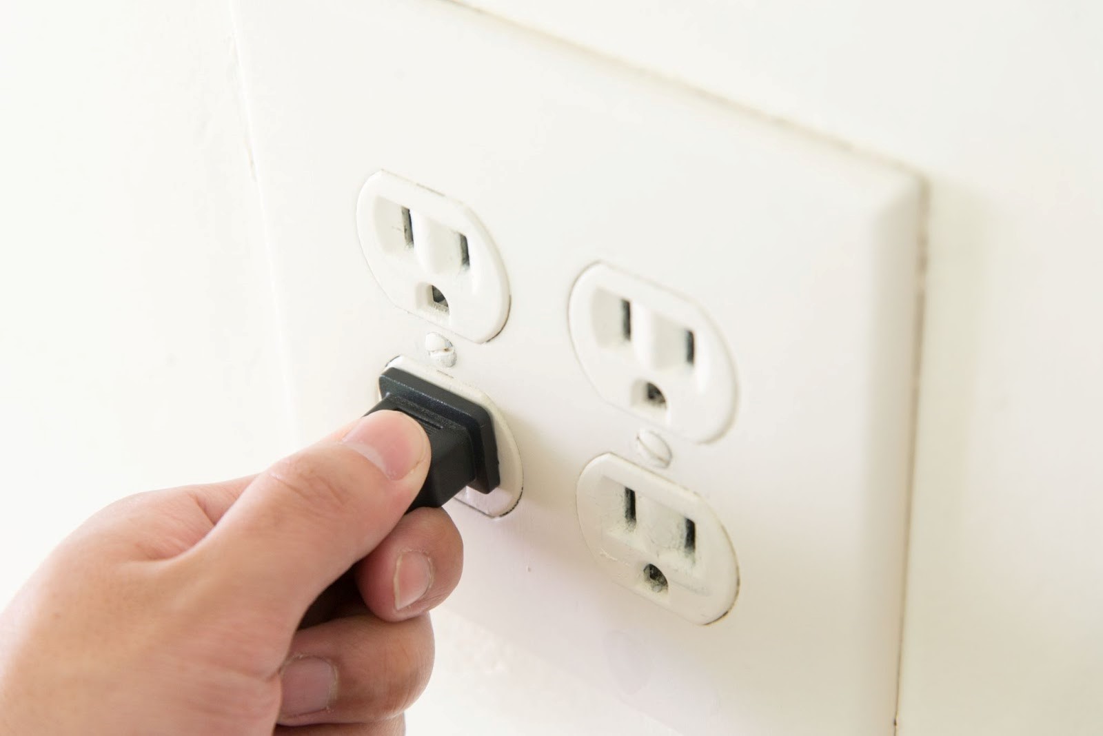Plugging a cord into a double wall outlet
