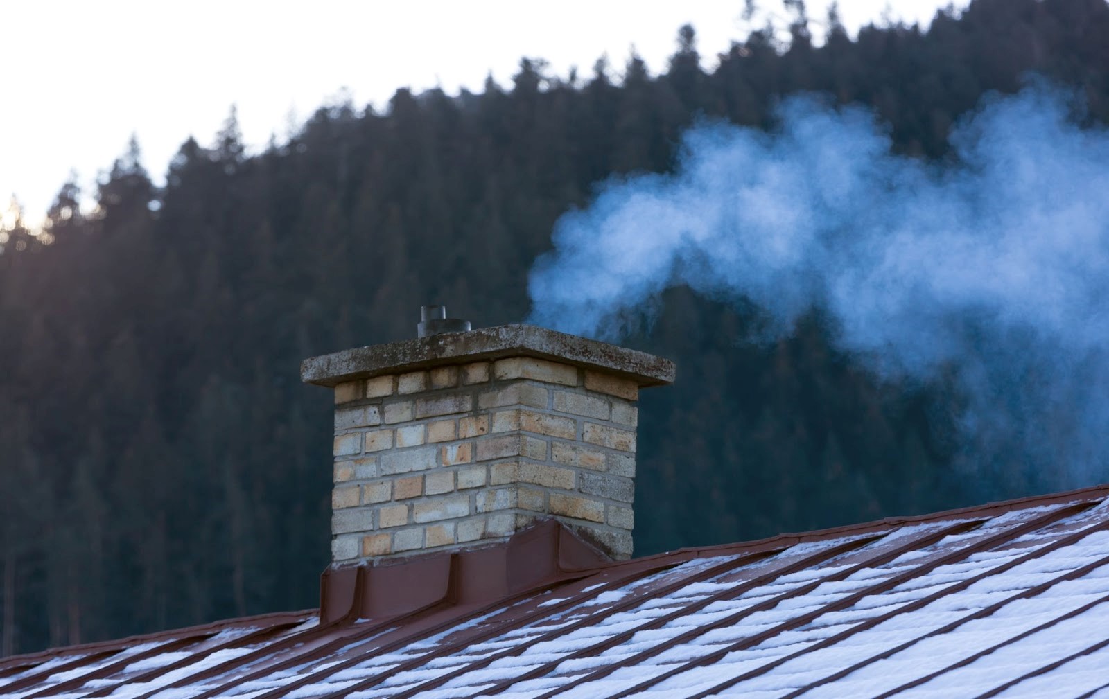 smoke from a chimney on the roof