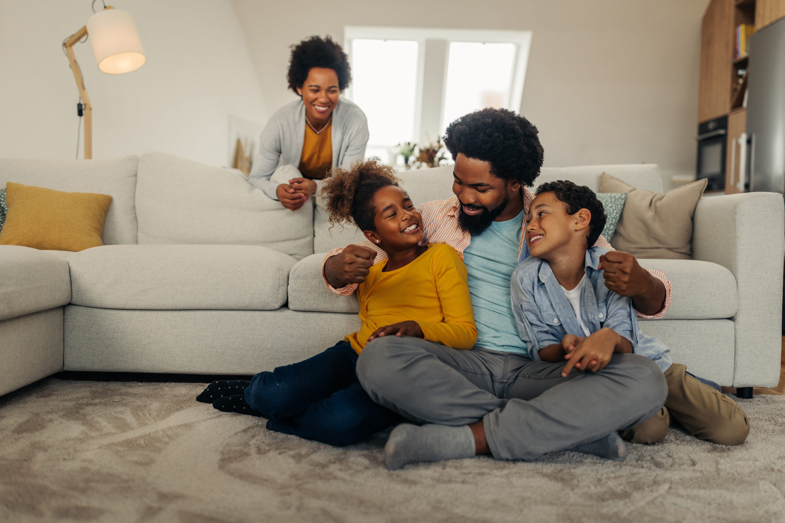 Family at home, enjoying their clean indoor air thanks to regularly changing their HVAC filters