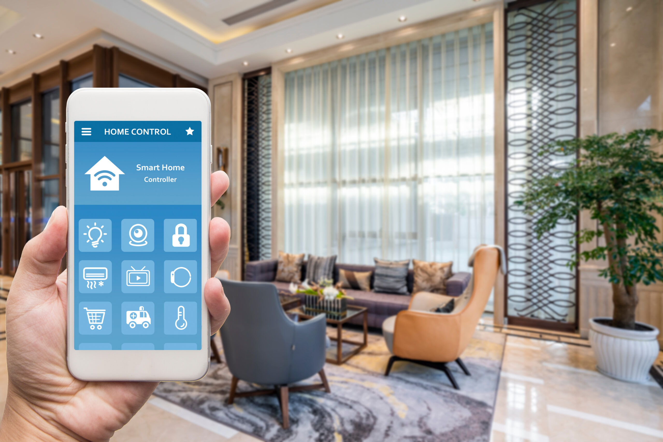 Hand holding a smartphone with smart home integration, home automation, device with app icons