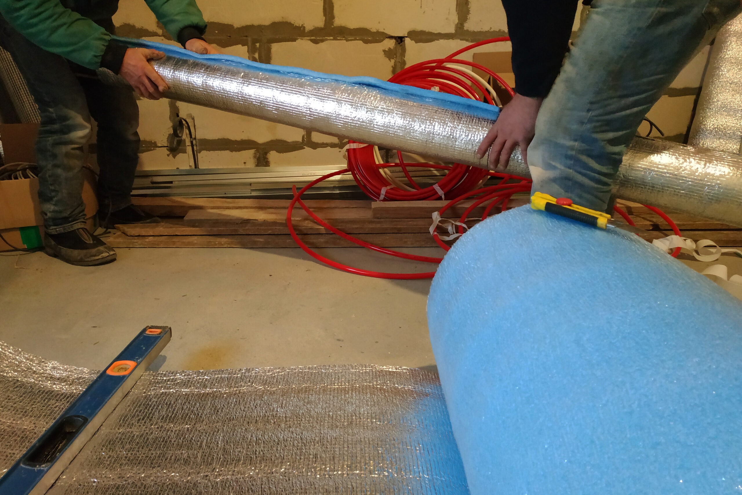HVAC professionals wrap the air duct with mineral wool and foil insulation