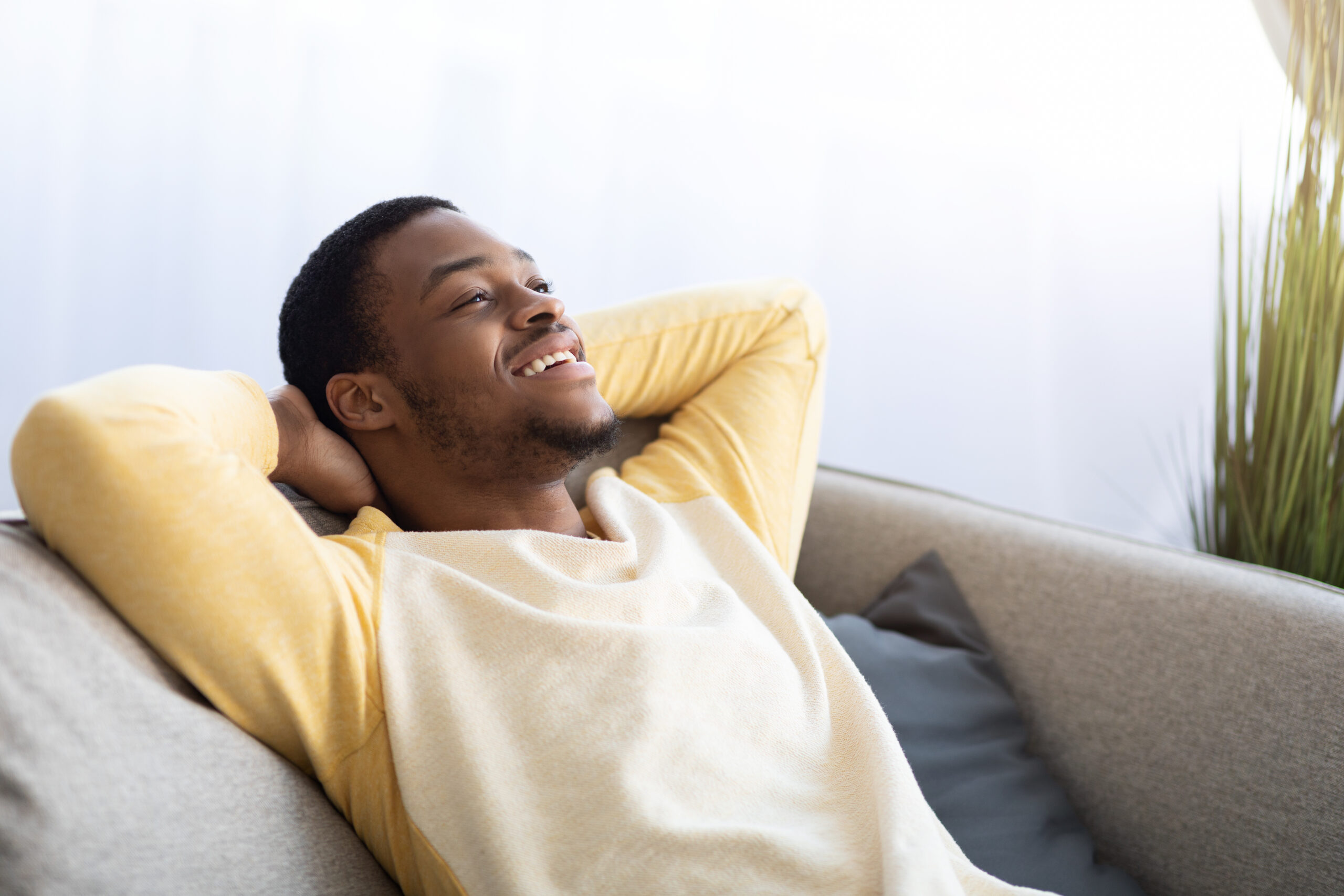 Closeup of man relaxing on couch at home