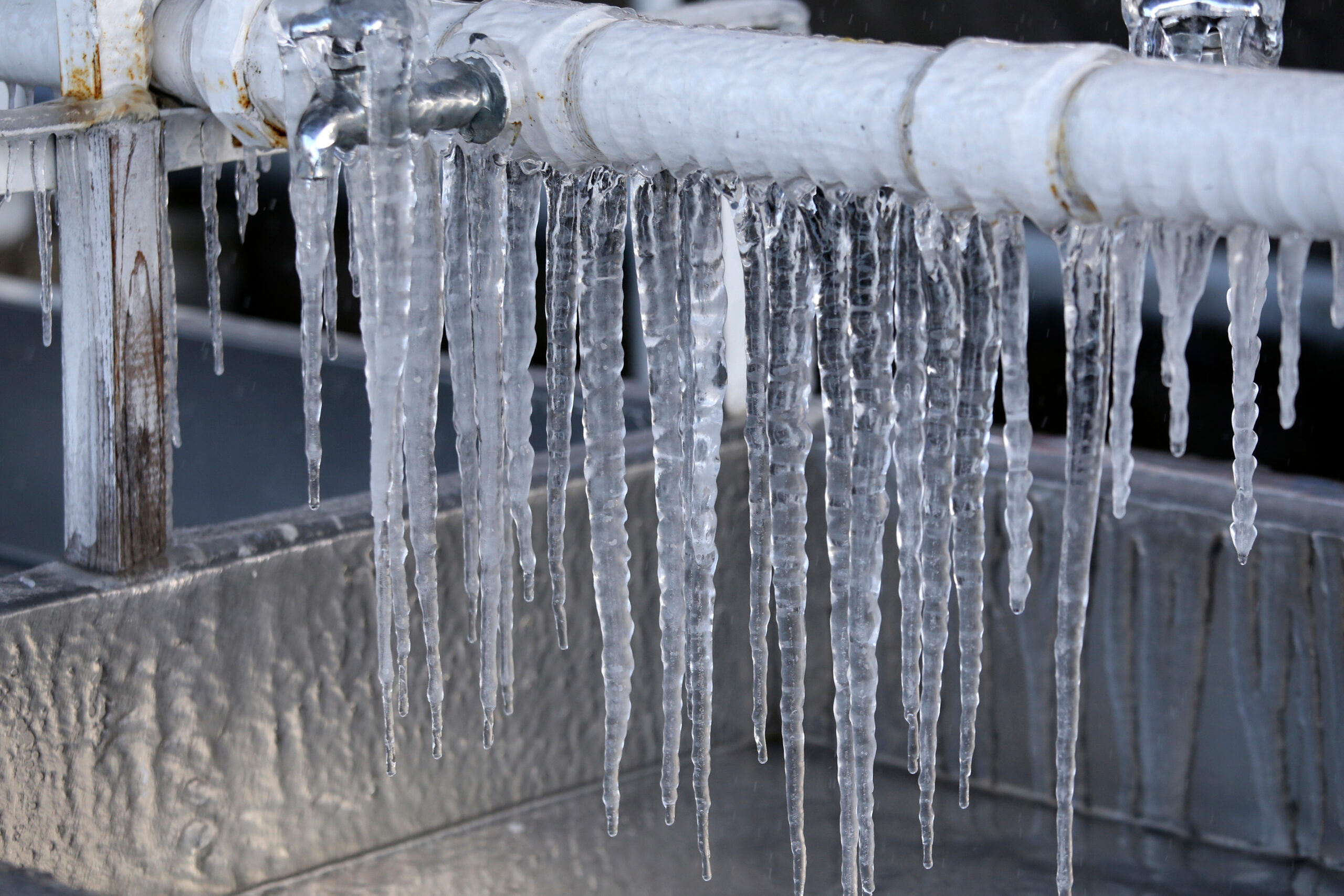 Frozen pipes and spigot with icicles